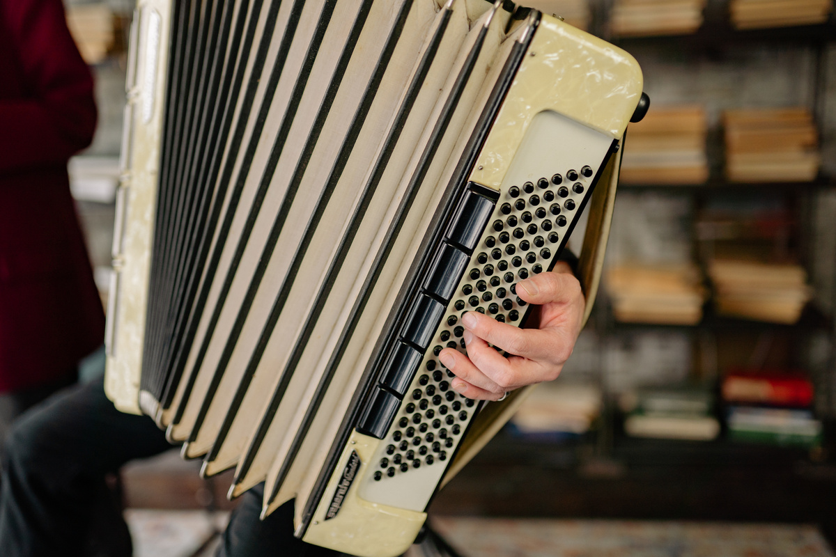 Close Up Photo of a Person Holding an Accordion